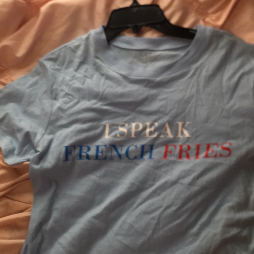 blue shirt that says “i speak french fries”